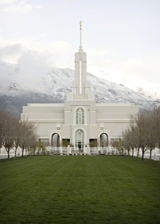 Large white building with bushes around